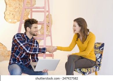 Young Man With Laptop And Woman, Shaking Hands