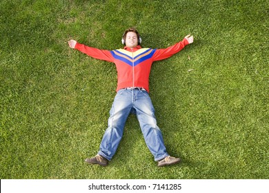 A Young Man Lay Down On The Grass Enjoying Good Music