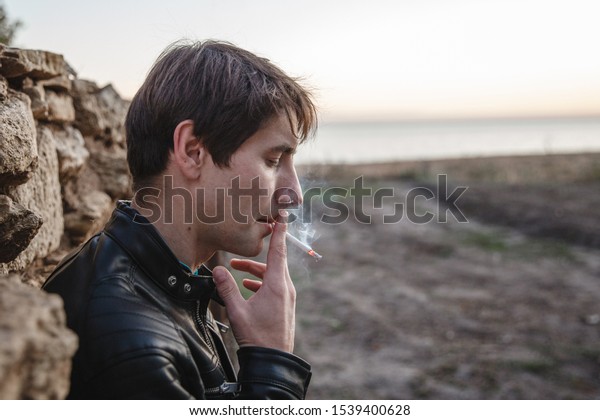 Young Man Leather Jacket Smoking Cigarette Stock Photo (Edit Now