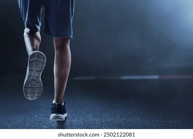 Young man legs running on the street at dark night with smoke - Powered by Shutterstock