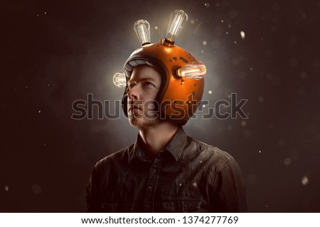 Young man with light bulb helmet