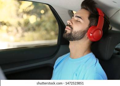 Young Man Listening To Audiobook In Car