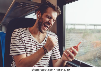 Young Man Listening To The Music On The Train