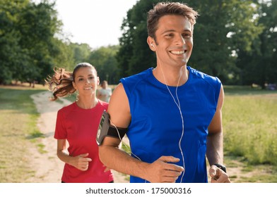 Young Man Listening To Music While Jogging With Woman  - Powered by Shutterstock