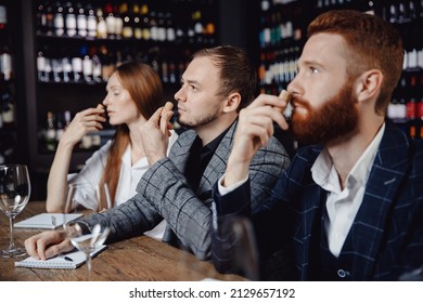 Young Man Listens To Aroma Of Red Wine At Master Class Tasting In Restaurant, Training Sommelier.