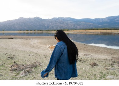 Young Man With Long Black Hair Turned From Behind In Nature