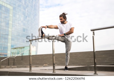 Similar – Athletic man warming up before running.