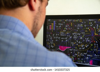 Young man looking at computer screen, rear view. High technology concept