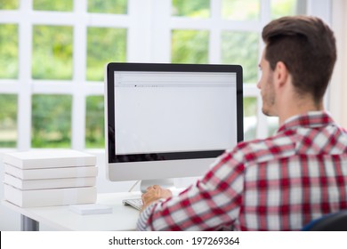 Young Man Looking At Computer Screen