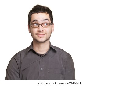 Young man looking at copyspace having a surprised or satisfied look isolated on white background
