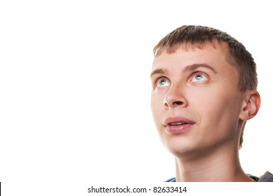 Young man looking at copyspace having a surprised look isolated on white background