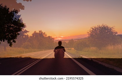 Young Man Looking Down A Long And Empty Road. Following Your Life Dreams Concept. 