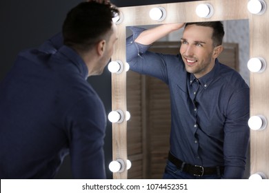 Young Man Looking At Himself In Mirror