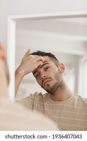 Young Man Looking In Mirror