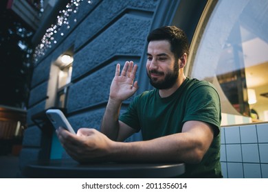 A Young Man Looking At The Mobile Phone Video Call Live Stream Outside