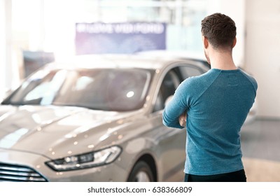 Young Man Looking At The New Car