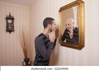 Young Man Looking At An Older Himself In The Mirror