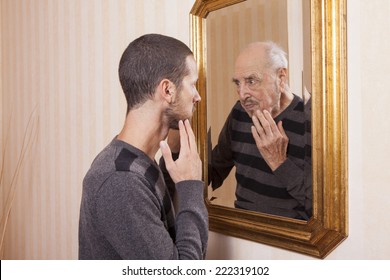 young man looking at an older himself in the mirror - Powered by Shutterstock