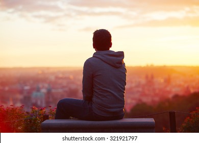 Young man is looking at the sunrise. - Shutterstock ID 321921797