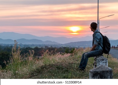 Young Man Is Looking At The Sunset.