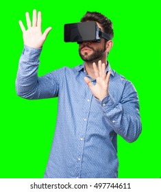 young man looking through a virtual reality glasses