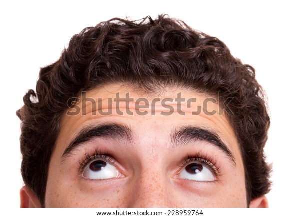 Young man looking up, isolated background