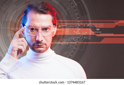 Young man looking at virtual graphics in futuristic background