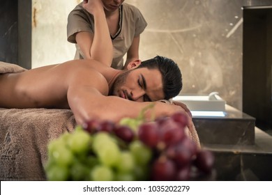 Young Man Lying Down During Traditional Acupressure Procedure Of Thai Massage At Luxury Spa And Wellness Center