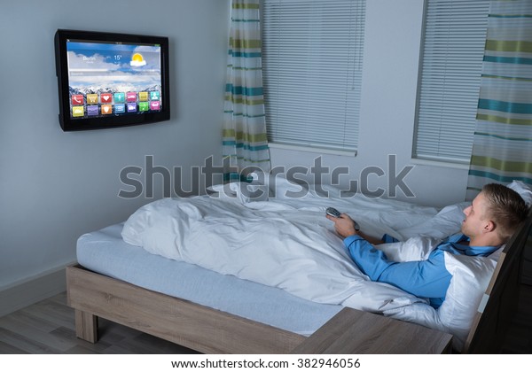 Young Man Lying On Bed Watching Stock Photo Edit Now 382946056