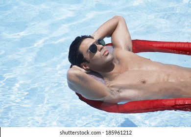 Young Man Lying On Pool Raft