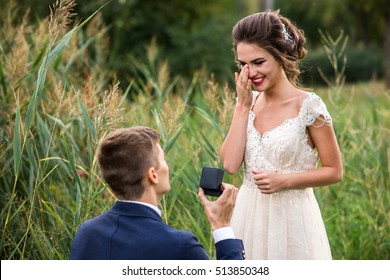 Young man makes a proposal to get married, the bride is crying from happiness