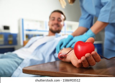 Young Man Making Blood Donation In Hospital, Focus On Hand