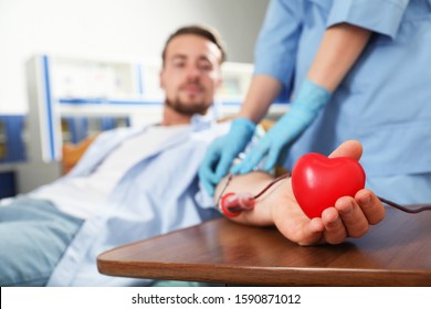 Young Man Making Blood Donation In Hospital, Focus On Hand