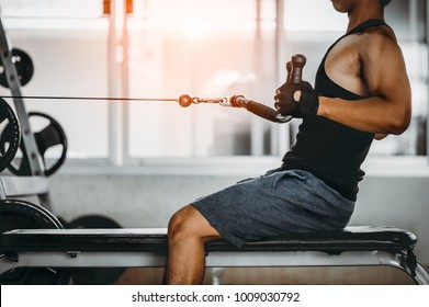 young man making low cable pulley row seated.Concept of healthy lifestyle.  bodybuilder in the gym.