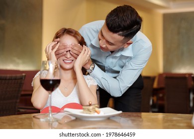 Young Man Making Romantic Surprise For Girlfriend In Fancy Restaurant