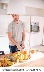 Young Man Making Smoothie On A Table On A Sunny Early Morning