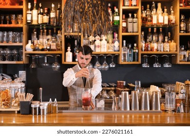 Young man making very special cocktails and creating experiences for consumption. Concept: bartender, mixologist, drinks - Powered by Shutterstock