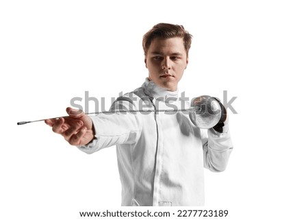 Young man, male fencer in fencing costume mask standing with sword over white studio background. Sport, motivation, professional skills. Copyspace for ad, text.