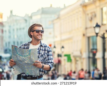 Young Man With A Map Outdoors