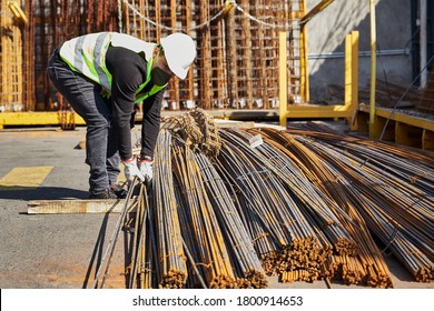 Young Man With Mask And Helmet In The Middle Of His Job As A Construction Tool Salesman, In The Middle Of Covid 19 Pandemic In The New Normal