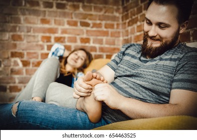 Young man massaging his lover's feet. - Powered by Shutterstock