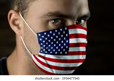 Young Man In A Medical Mask, With The Flag Of America On The Mask.