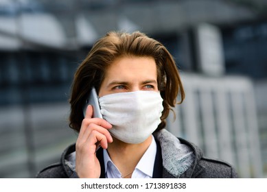 Young Man In A Medical Mask Outside, No Money, Crisis, Poverty, Hardship. Quarantine, Coronavirus, Isolation.