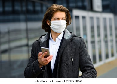 Young Man In A Medical Mask Outside, No Money, Crisis, Poverty, Hardship. Quarantine, Coronavirus, Isolation.