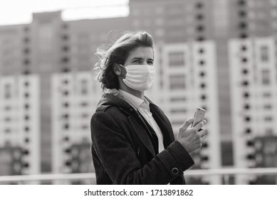 Young Man In A Medical Mask Outside, No Money, Crisis, Poverty, Hardship. Quarantine, Coronavirus, Isolation.