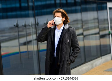 Young Man In A Medical Mask Outside, No Money, Crisis, Poverty, Hardship. Quarantine, Coronavirus, Isolation.