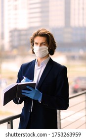 Young Man In A Medical Mask Outside, No Money, Crisis, Poverty, Hardship. Quarantine, Coronavirus, Isolation.