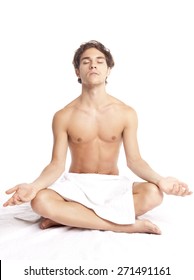 Young Man Meditating With Towel Around Waist