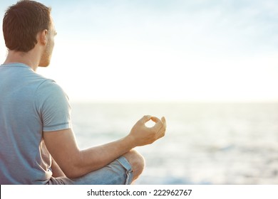 Young Man In Meditation Near The Sea