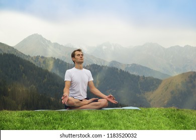 Young man in meditation. Outdoor yoga in mountains